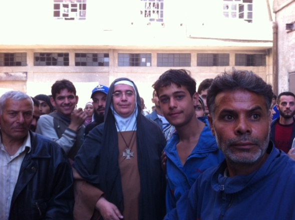 Joined by Sister Carmel and two members of her team, Mother Agnès-Mariam is welcomed by the men of the revolution came without their weapons.